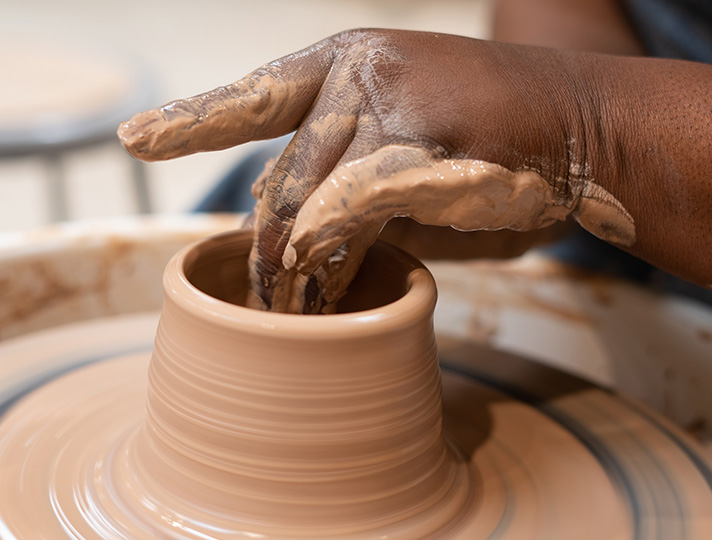 Student using ceramics wheel